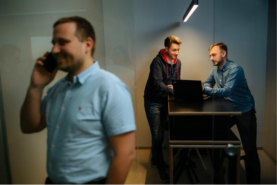 A group of men in an officeDescription automatically generated